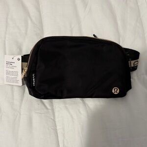 lululemon athletica Black Crossbody Belt Bag with Gold Accents